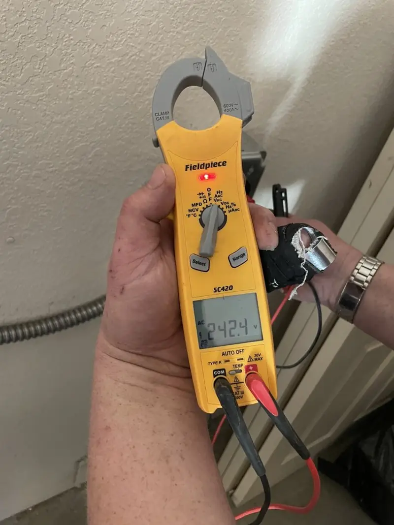 Voltage testing with clamp meter during Ceiling Fan Installation in Zachary